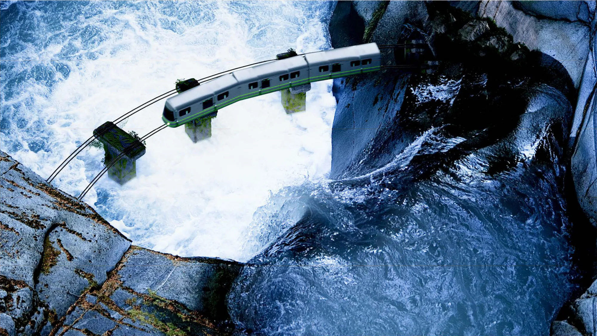 A green commuter train crossing a thin bridge over a churning blue river gorge, seen from above.